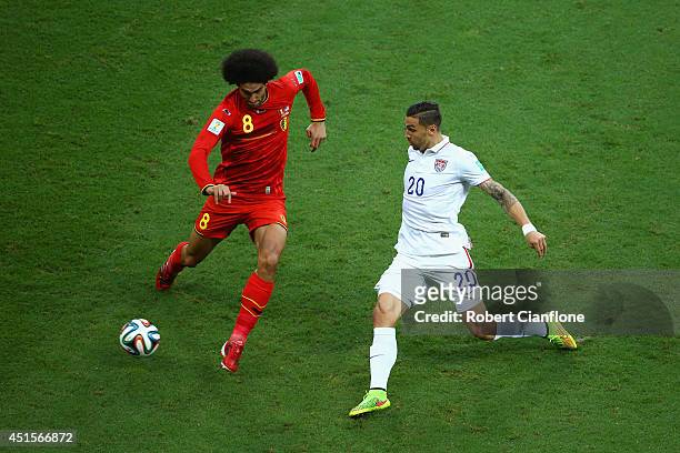 Geoff Cameron of the United States challenges Marouane Fellaini of Belgium during the 2014 FIFA World Cup Brazil Round of 16 match between Belgium...