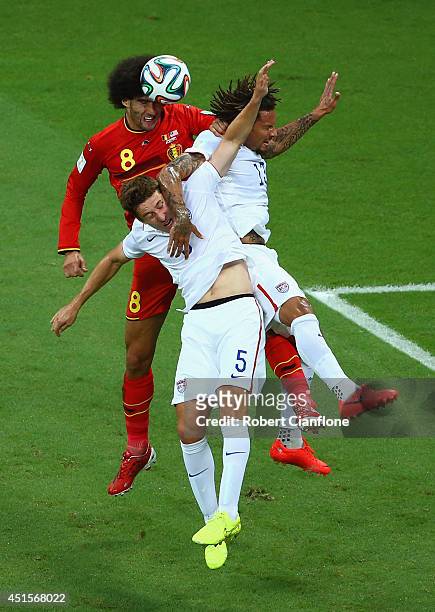 Marouane Fellaini of Belgium goes up for a header against Matt Besler and Jermaine Jones of the United States during the 2014 FIFA World Cup Brazil...