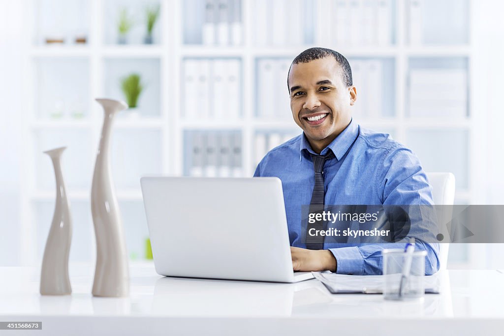 African American businessman using laptop.