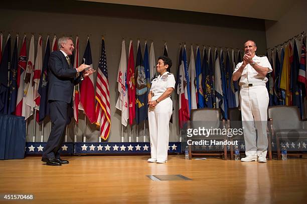 In this handout photo provided by the U.S. Navy, Secretary of the Navy Ray Mabus and Chief of Naval Operations Adm. Jonathan Greenert applaud Adm....