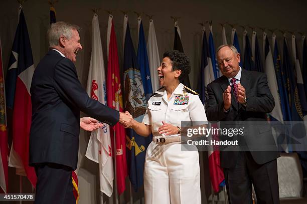 In this handout photo provided by the U.S. Navy, Secretary of the Navy Ray Mabus congratulates Adm. Michelle Howard after putting on her fourth star...