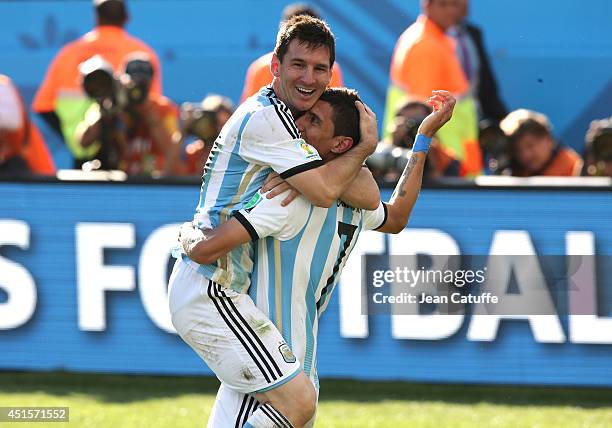 Lionel Messi of Argentina celebrates the winning goal with Angel Di Maria who scored it during the 2014 FIFA World Cup Brazil Round of 16 match...