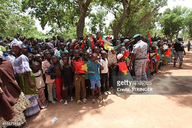 Children holding Burkina Faso's flags wait for the visit of Burkina Faso's President in Segou, northeast of Bamako, on July 1, 2014. Burkina Faso's...