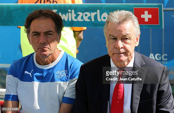 Assistant-coach of Switzerland Michel Pont and head coach Ottmar Hitzfeld look on prior to the 2014 FIFA World Cup Brazil Round of 16 match between...