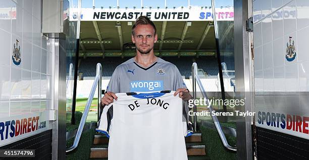 New signing Siem de Jong poses for photographs in the tunnel holding a Newcastle United Shirt at St.James' Park on July 01, 2014 in Newcastle upon...