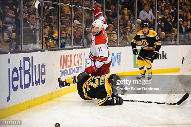 Eric Staal of the Carolina Hurricanes checks against Jarome Iginla of the Boston Bruins at the TD Garden on November 23, 2013 in Boston,...