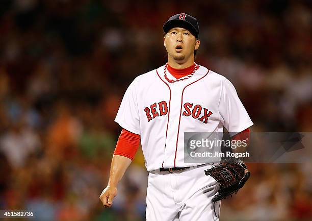Junichi Tazawa of the Boston Red Sox reacts after throwing a scoreless eighth inning against the Chicago Cubs at Fenway Park on July 1, 2014 in...