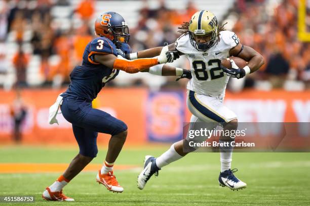 Manasseh Garner of the Pittsburgh Panthers fends off Durell Eskridge of the Syracuse Orange during a third quarter reception on November 23, 2013 at...