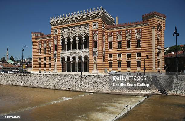 The Miljacka river flows past City Hall, called the Vijecnica and is the former National Library that was destroyed by Serbian shelling during the...