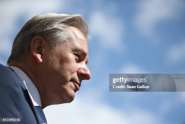 Berlin Mayor Klaus Wowereit speaks to a journalist as a blue sky is visible behind following an event on July 1, 2014 in Berlin, Germany. Wowereit is...