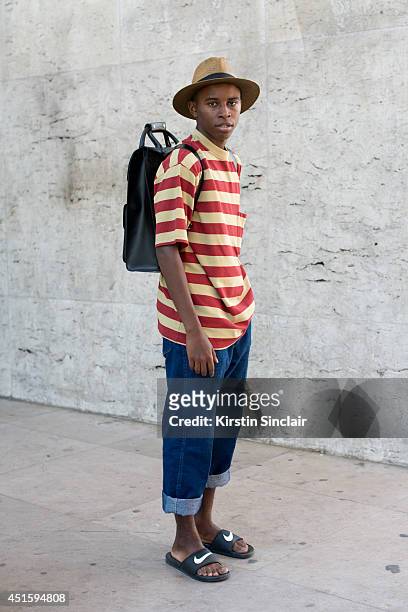 Fashion blogger Jalan Durimel wearing a Gap T shirt, vintage jeans, Nike sandals, Milani hat and Doc Martins bag on day 2 of Paris Collections: Men...