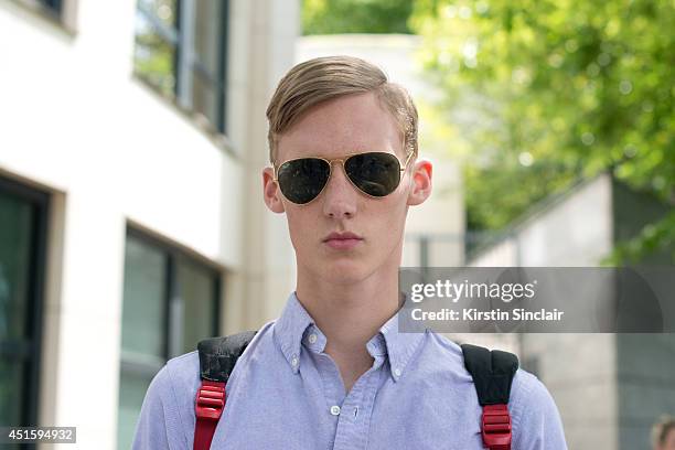 Model Carl Axlesson wearing a Ralph Lauren shirt, Ray Ban sunglasses on day 2 of Paris Collections: Men on June 26, 2014 in Paris, France.