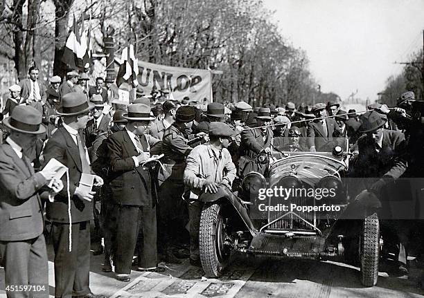 Italian racing car driver Tazio Nuvolari being pushed to the start of the Mille Miglia in his Tipo 8C 2300 Alfa Romeo, assisted by his...