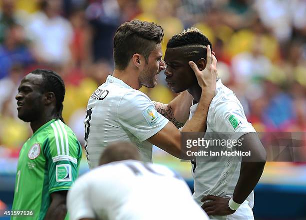 Olivier Giroud of France consoles Paul Pogba of France during the 2014 FIFA World Cup Brazil Round of 16 match between France and Nigeria at the...