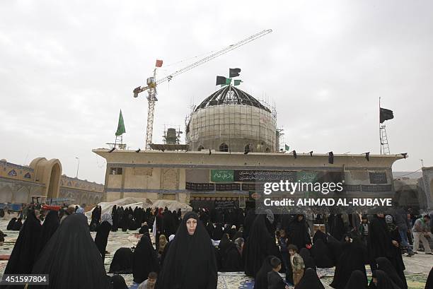 Under repair, pilgrims visit the Al-Askari which embraces the tombs of the 10th and 11th Imams, Ali Al-Hadi who died in 868 AD and his son Hassan...