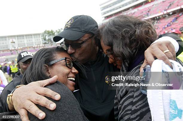 East Carolina head coach Ruffin McNeill celebrates with his daughter Olivia, left, and wife Erlene at the end of the Pirates' game against N.C. State...