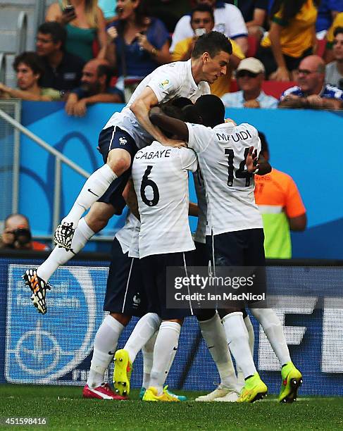 Laurent Koscielny of France joins in on Paul Pogba's goal celebration during the 2014 FIFA World Cup Brazil Round of 16 match between France and...
