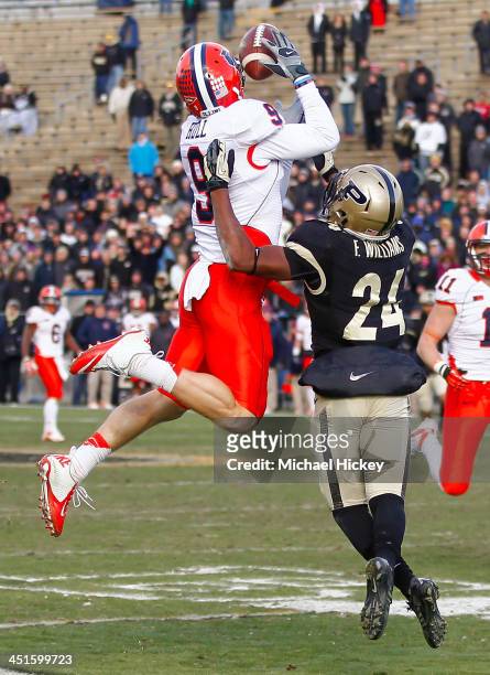 Steve Hull of the Illinois Fighting Illini goes up for a pass reception as Frankie Williams of the Purdue Boilermakers defends at Ross-Ade Stadium on...
