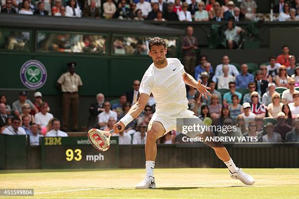 Bulgaria's Grigor Dimitrov returns to Britain's Andy Murray during their men's singles quarter-final match on day nine of the 2014 Wimbledon...