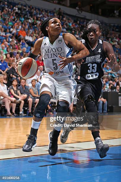 Tan White of the Minnesota Lynx drives to the basket against during the WNBA game against the San Antonio Stars on May 30, 2014 at Target Center in...