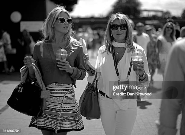 Fans walking around Wimbledon Tennis drinking pimms on day nine of the Wimbledon Lawn Tennis Championships at the All England Lawn Tennis and Croquet...