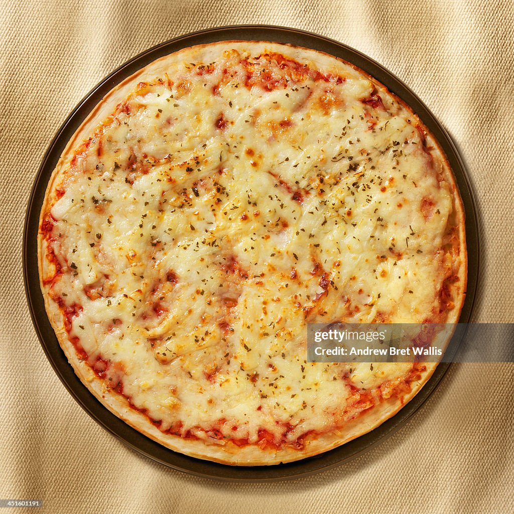 Overhead of freshly baked cheese and tomato Pizza