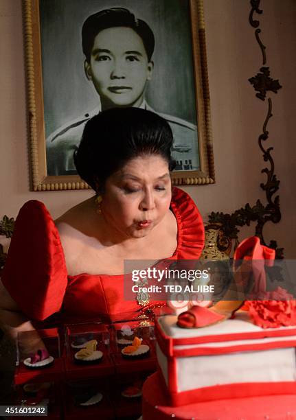 Philippine former first lady and now congresswoman, Imelda Marcos blows out the candles on a cake designed with a shoe during her 85th birthday...