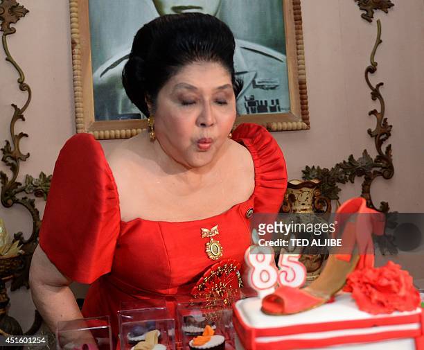 Philippine former first lady and now congresswoman, Imelda Marcos blows out the candles on a cake designed with a shoe during her 85th birthday...