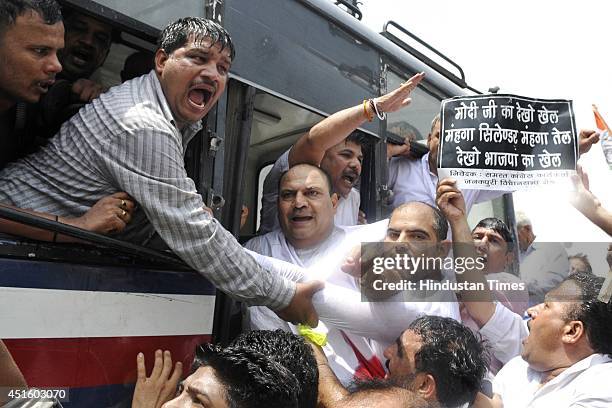 Congress leader Mukesh Sharma along with workers protest against the price rise of petrol, diesel, gas and vegetables at Uttam Nagar on July 2, 2014...