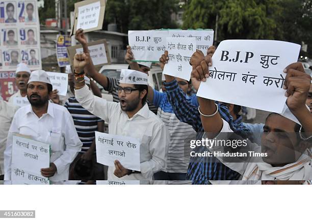 Aam Aadmi Party members hold a demonstration against petroleum price hike and so called 'acchhe din' at Pragati Petrol Pump Square on July 2, 2014 in...