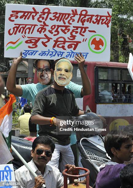 Youth Congress activists wearing masks of Prime minister Narendra Modi and Chief minister Shivraj Singh Chouhan taking out a rally to protest against...