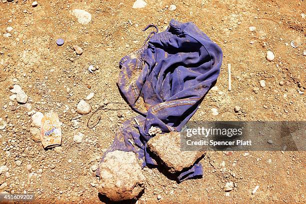 Discarded pair of pants is viewed on the ground outside of the processing center at a temporary displacement camp on July 2, 2014 in Khazair, Iraq....