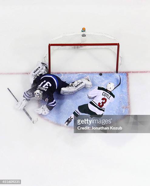 Charlie Coyle of the Minnesota Wild dekes out goaltender Ondrej Pavelec of the Winnipeg Jets and slides the puck into the net to clinch the 3-2...