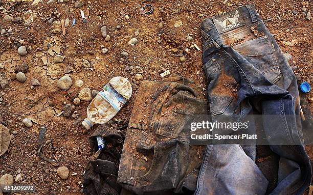 Discarded clothes are viewed on the ground outside of the processing center at a temporary displacement camp on July 2, 2014 in Khazair, Iraq. The...