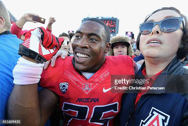 Running back Ka'Deem Carey of the Arizona Wildcats celebrates on the field after defeating the Oregon Ducks 42-16 in the college football game at...