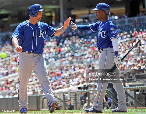 Jarrod Dyson of the Kansas City Royals congratulates teammate Raul Ibanez on scoring a run against the Minnesota Twins during the second inning of...