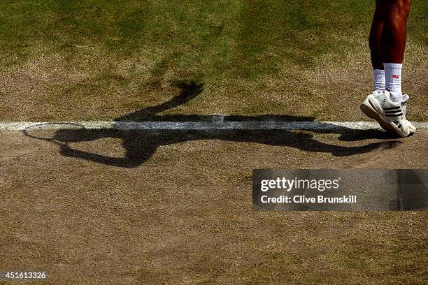 Detail shot of the shadow of Novak Djokovic of Serbia as he serves during his Gentlemen's Singles quarter-final match against Marin Cilic of Croatia...