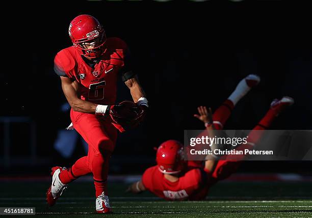 Wide receiver Nate Phillips of the Arizona Wildcats runs with the football after a reception from quarterback B.J. Denker during the college football...