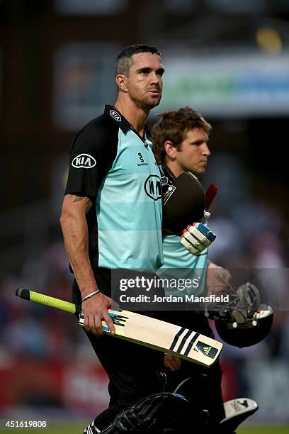 Kevin Pietersen and Gary Wilson of Surrey walk off not out after Surrey win during the Natwest T20 Blast match between Surrey and Kent Spitfires at...
