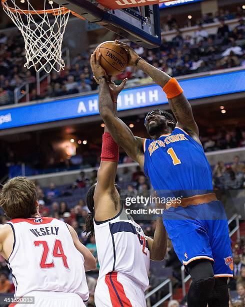 New York Knicks power forward Amar'e Stoudemire shoots over Washington Wizards power forward Nene Hilario during the first half of their game played...