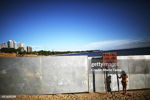 Woman speaks on her phone at Ponta Negra beach on Rio Negro, a branch of the Amazon River, on November 23, 2013 in Manaus, Brazil. Manaus' Arena...