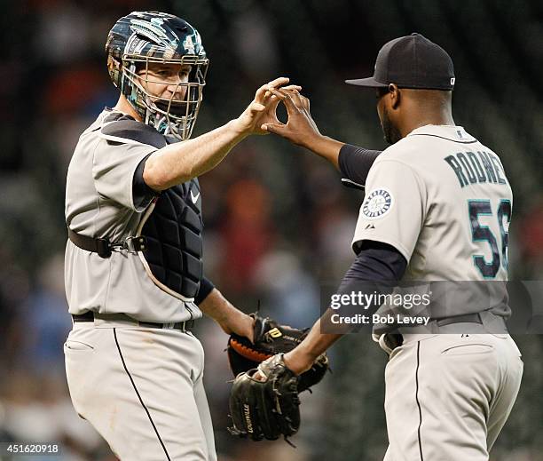Fernando Rodney of the Seattle Mariners high fives John Buck after the final out as the Seattle Mariners defeated the Houston Astros 5-2 at Minute...