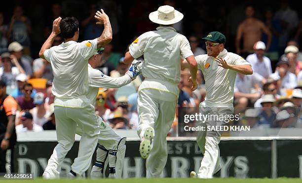 Australian players run to greet substitute fielder Chris Sabburg who takes a catch to dismiss England's Kevin Pietersen at the boundary line during...