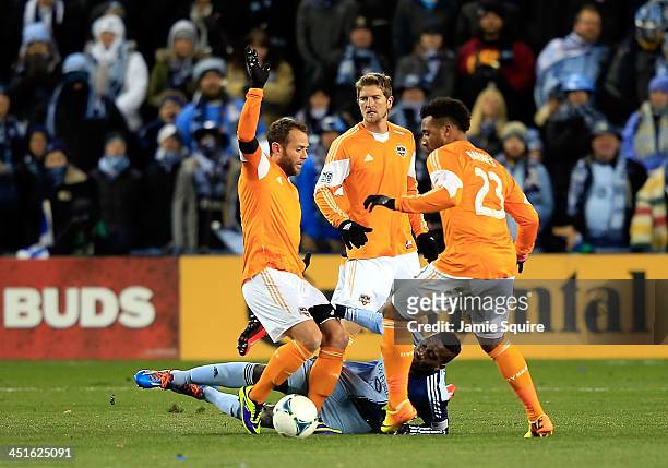 Sapong of the Sporting KC is upended by Houston Dynamo players during Leg 2 of the Eastern Conference Championship at Sporting Park on November 23,...