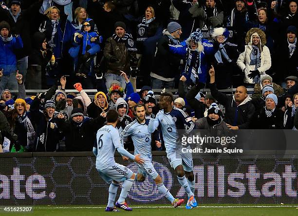 Sporting KC fans cheer as Paulo Nagamura and Graham Zusi celebrate a goal by C.J. Sapong during Leg 2 of the Eastern Conference Championship against...