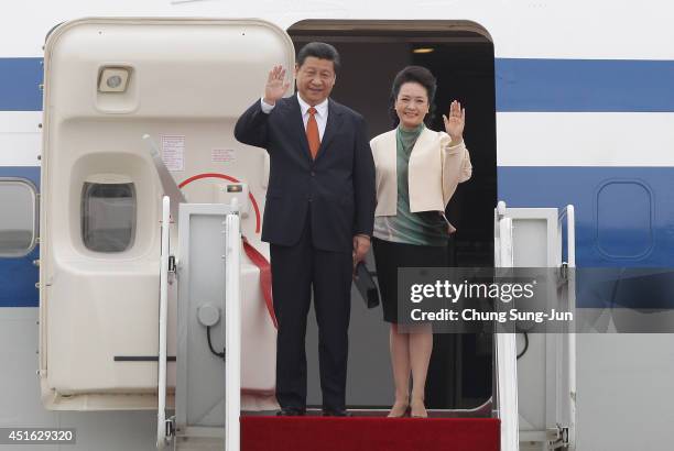 Chinese President Xi Jinping and his spouse Peng Liyuan arrive at Seoul military airport on July 3, 2014 in Seoul, South Korea. President Xi Jinping...