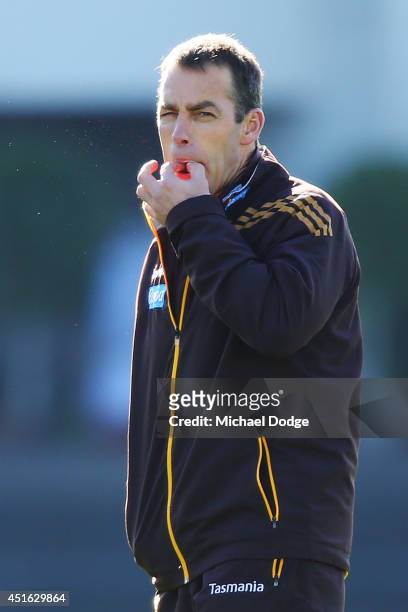 Hawks coach Alastair Clarkson, recovering from serious illness, whistles loudly for the players to finish a Hawthorn Hawks AFL training session at...