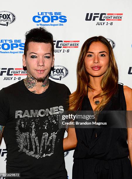 Guitarist Dj Ashba of Guns N' Roses and wife, model Nathalia Henao, arrive at UFC's advance screening of the Twentieth Century Fox film 'Let's Be...