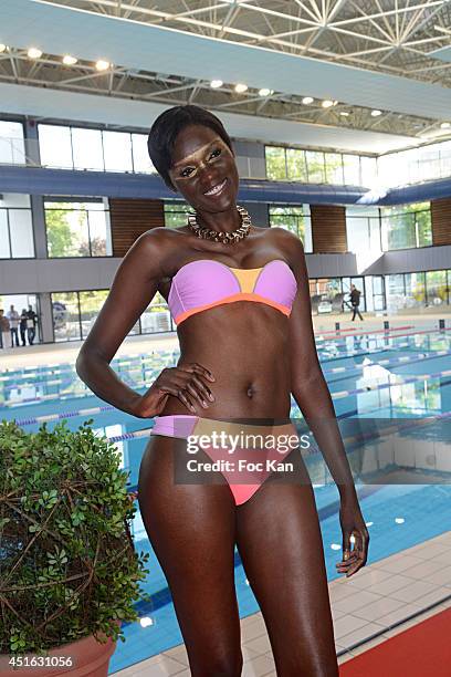 Model dressed by Laure Manaudou walks the runway during the 'Laure Manaudou Design' Swimming Suit show at Piscine Billancourt on July 2, 2014 in...