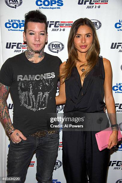 Guitarist Dj Ashba of Guns N' Roses and wife, model Nathalia Henao, arrive at UFC's advance screening of the Twentieth Century Fox film 'Let's Be...
